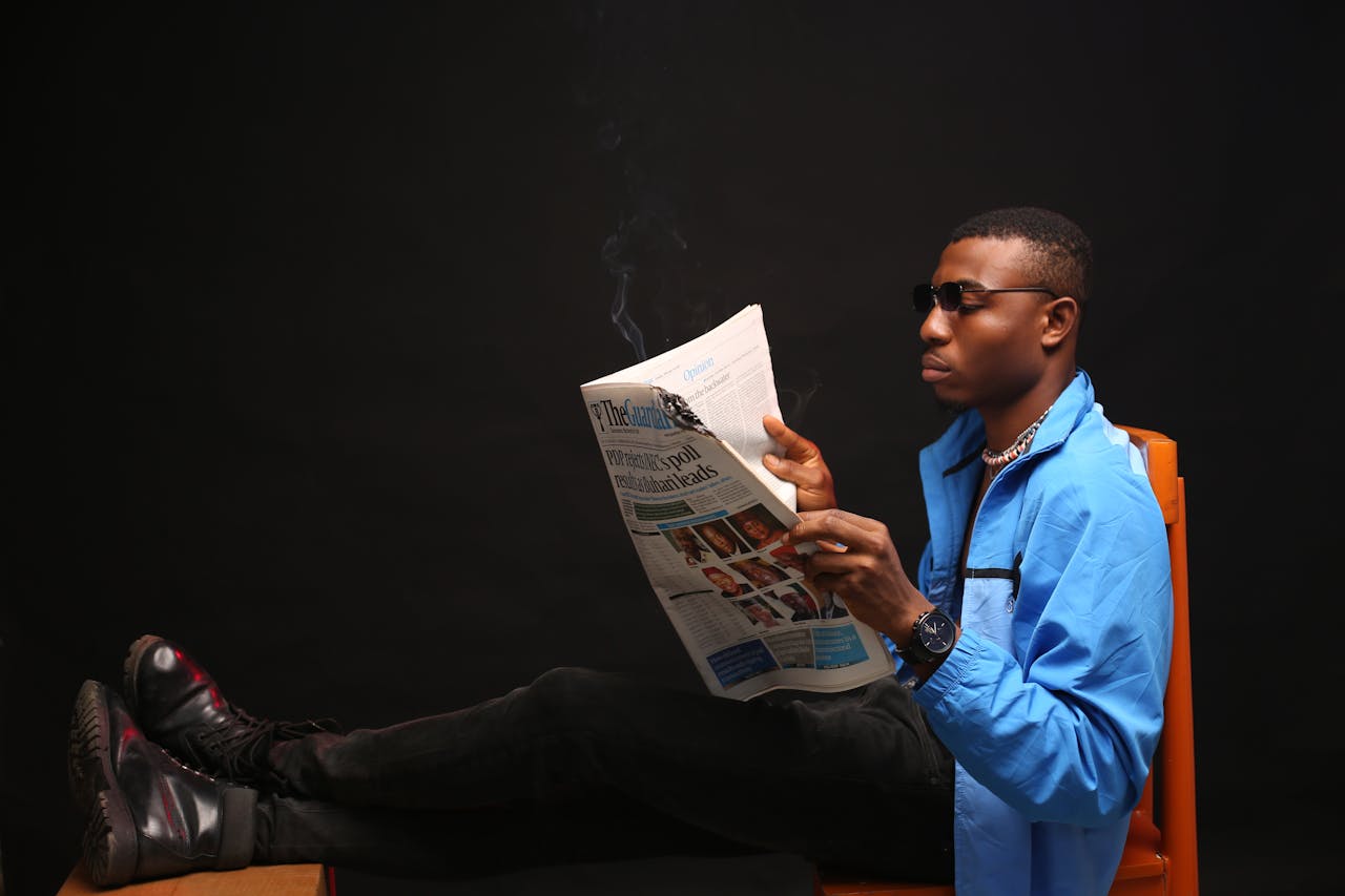 A Man Reading A News Paper